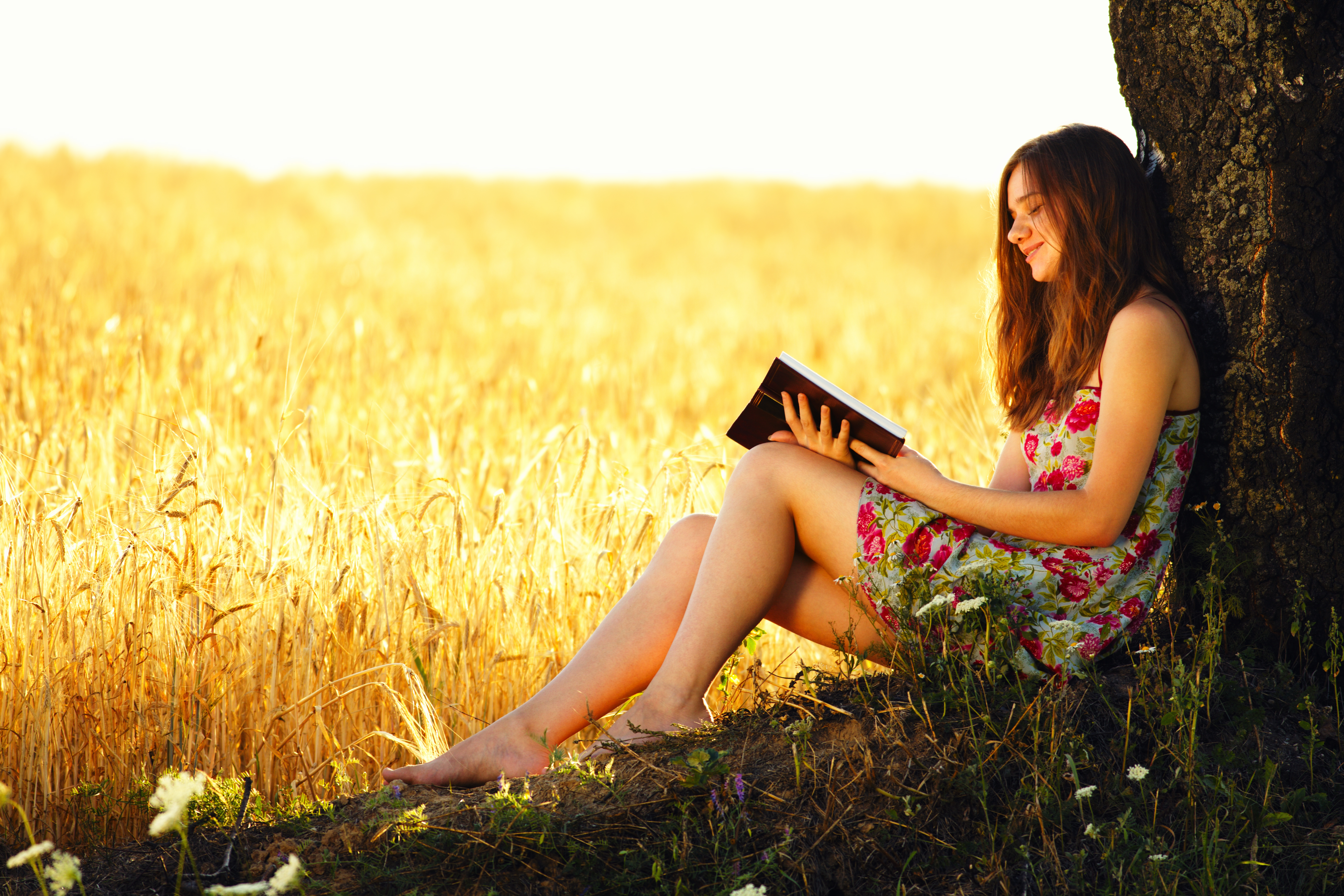 Young woman reading on nature